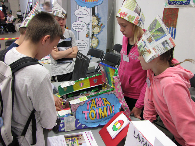 Children are showcasing their project work in a science fair.