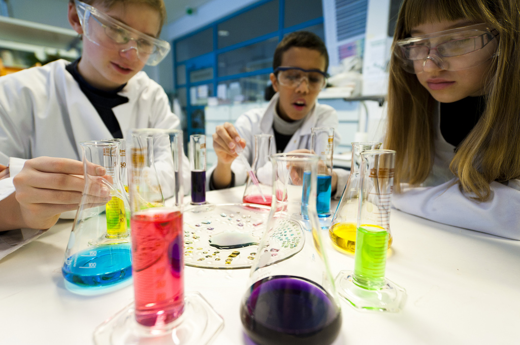 Young people performing a science experiment in chemistry lab Gadolin.